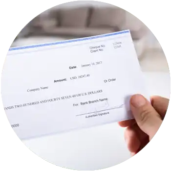 A light-skinned hand holds a signed blue and white check for $10,247.40.